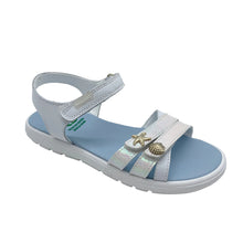 Load image into Gallery viewer, A children's white and light blue sandal with metallic iridescent straps and small decorative shell and star charms, shown on a light gray background.