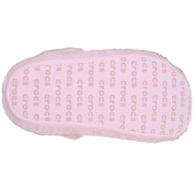 Load image into Gallery viewer, A single Crocs slipper shown from the sole side, featuring a light pink textured sole with repeating Crocs logos and a fluffy light pink faux-fur trim, set against a solid black background.