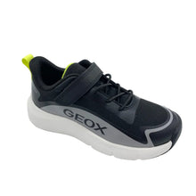 Load image into Gallery viewer, A black and gray Geox sneaker with a white sole and a bright neon yellow pull tab, shown on a light gray background.
