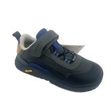 Load image into Gallery viewer, A toddler's dark gray and navy blue Vibram safety shoe with a hook-and-loop strap closure, a gray pull tab, and a small tan accent on the heel, shown on a white background with its paper tag still attached.