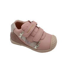 Load image into Gallery viewer, A single toddler's pink sneaker with two hook-and-loop straps, decorative silver glitter unicorn embellishments on the side, and a beige sole, shown on a light gray background.