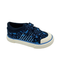 Load image into Gallery viewer, A navy blue canvas shoe with a dino print, featuring a non-slip rubber sole and double velcro fastenings.