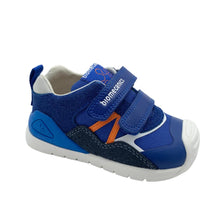 Load image into Gallery viewer, A blue toddler sneaker with hook-and-loop straps, featuring a navy textured panel, an orange side accent, and a white rubber sole, shown on a white background.