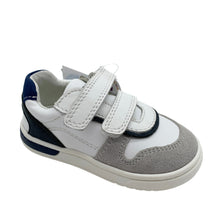 Load image into Gallery viewer, A child's leather trainer shoe in white, navy, and grey colors, featuring a velcro fastening and elastic laces.
