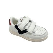 Load image into Gallery viewer, A white leather child's sneaker with double velcro fastenings, navy, and red trim, and a non-slip rubber sole.