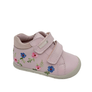 Pink children's shoe with floral design on a white background