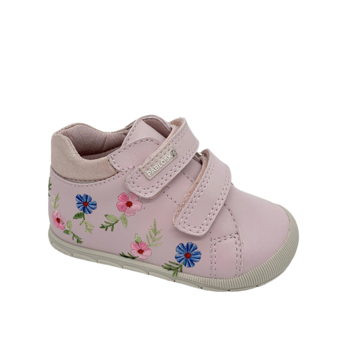 Pink children's shoe with floral design on a white background
