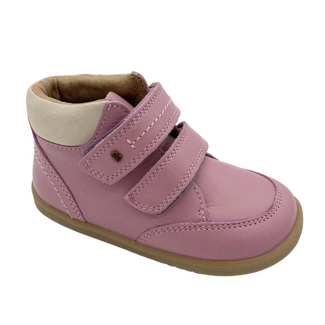 Pink children's shoe with a strap on a white background