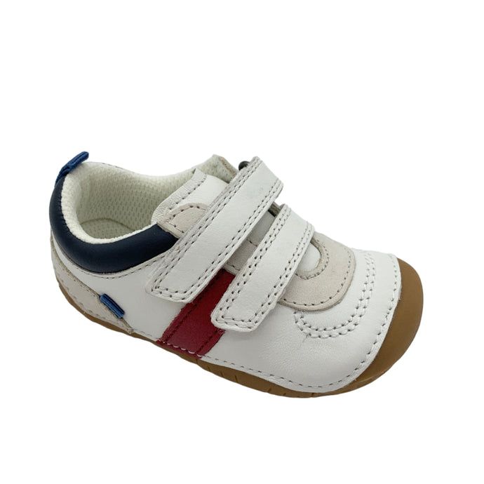 White children's shoe with brown sole and red and blue accents on a white background