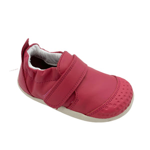 Red children's shoe with a velcro strap on a white background