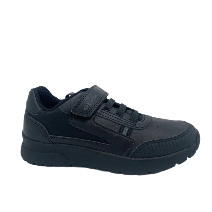 Black sneaker with velcro straps on a white background