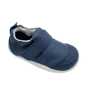 Navy blue children's shoe with a velcro strap on a white background