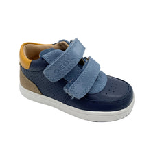 Load image into Gallery viewer, A toddler's low-top sneaker in navy blue, light blue suede, and tan, featuring two hook-and-loop straps and a white sole, photographed on a white studio background.
