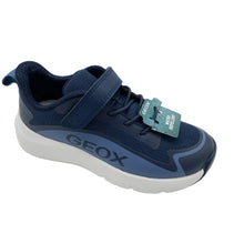 Load image into Gallery viewer, A navy blue Geox toddler sneaker with a hook-and-loop strap closure, a white and navy sole, and a green Geox retail tag attached, photographed on a white studio background.
