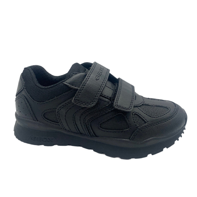 Black shoe with velcro straps on a white background