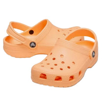 Load image into Gallery viewer, A pair of Crocs classic clogs in a vibrant peach-orange color, displayed on a clean white background.
