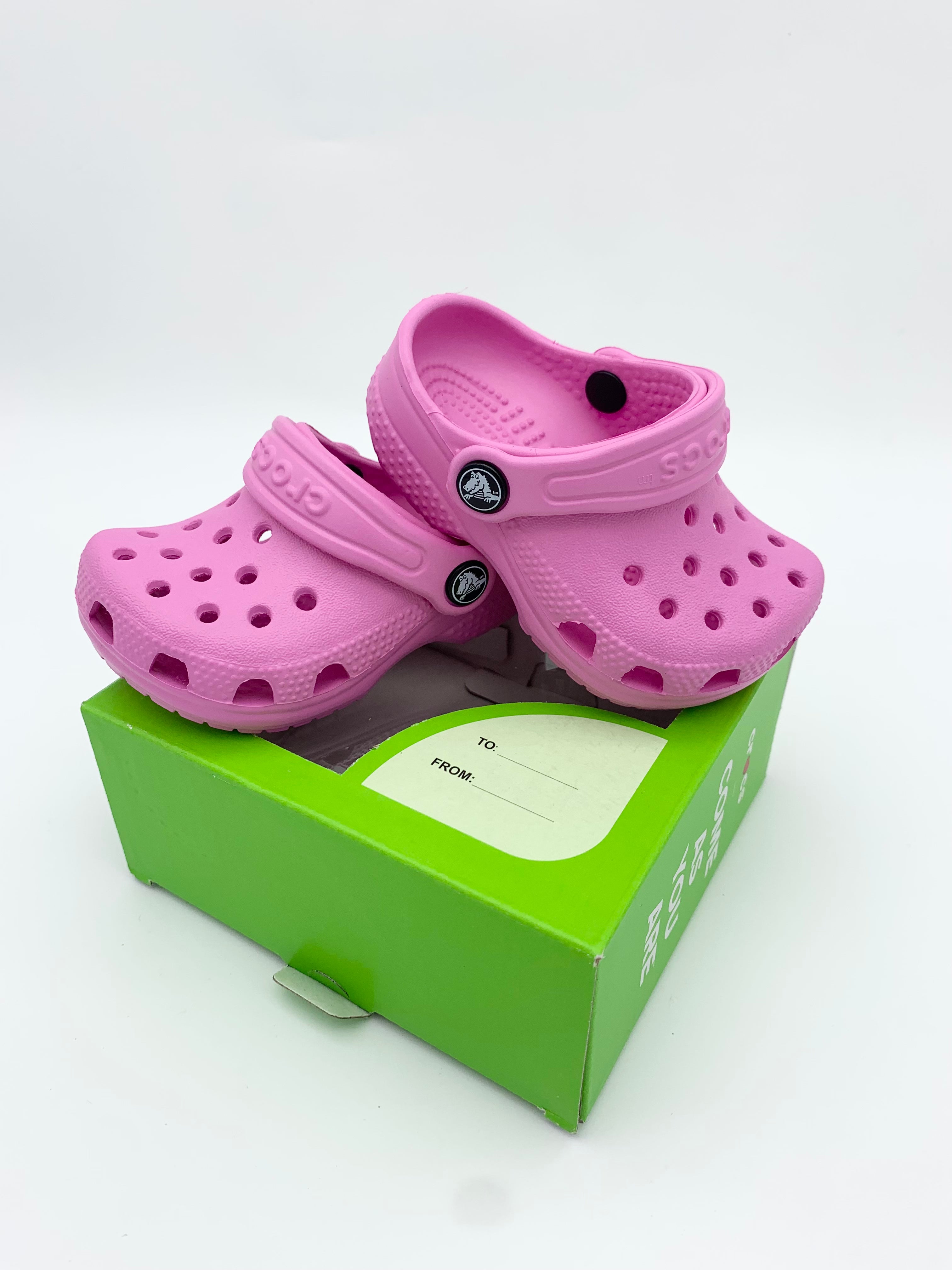 Pink and store green crocs