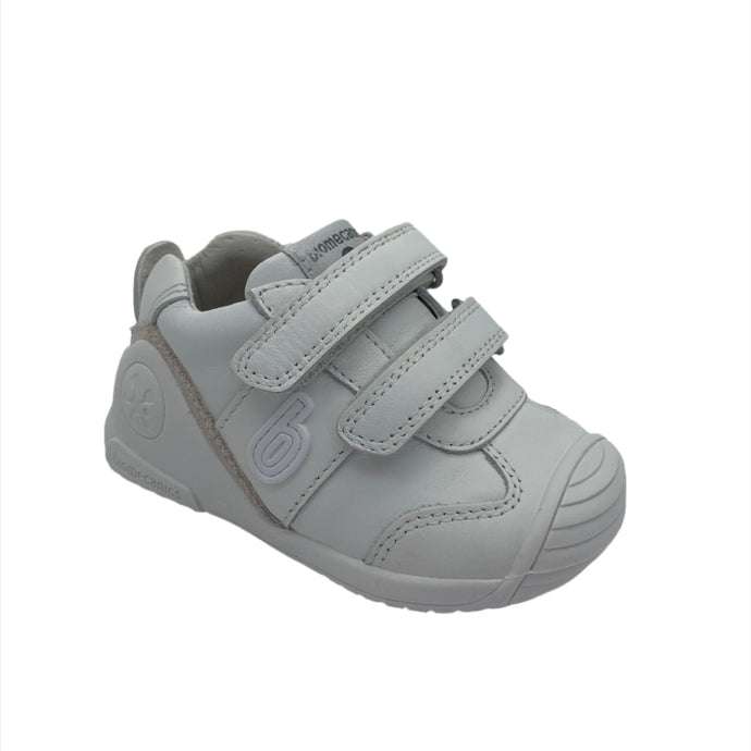 A white Biomechanics trainer shoe with double velcro fastening and a leather upper.