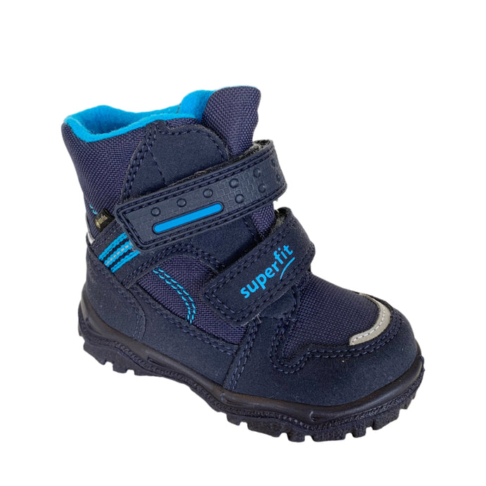 Children's navy and blue waterproof boot with double velcro straps and a visible fleece lining.