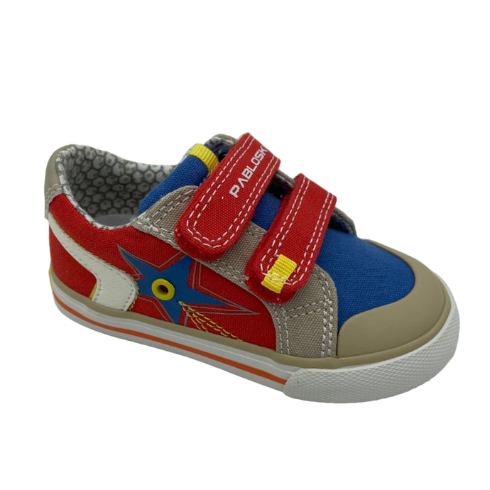 A children's Pablosky canvas shoe with red, blue, and orange colors, featuring a non-slip sole and double velcro fastening.